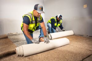 Contractors removing carpet
