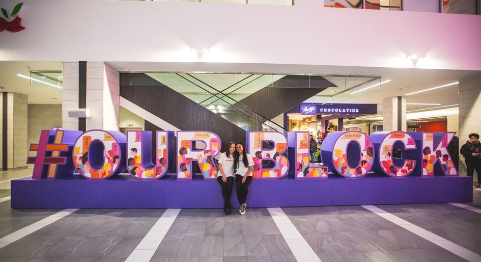 Students from Cardinal Carter Academy for the Arts pose with the newly unveiled #OurBlock installation, which they designed for the redeveloped Yonge Sheppard Centre.