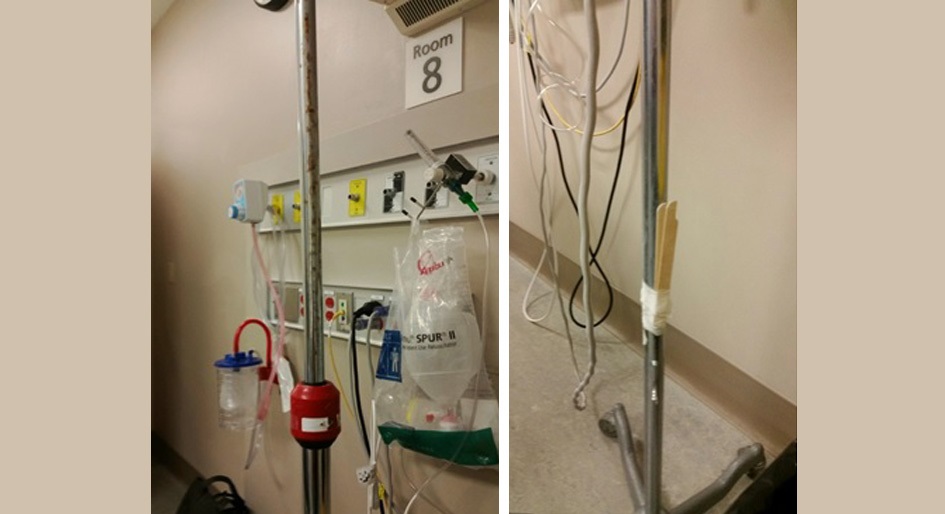 Rusted IV pole with modified Foley holder at base (wood tongue compressors wrapped in tape). Seen in isolation room of large acute care emergency department in Ontario. Photo by Keith Sopha.